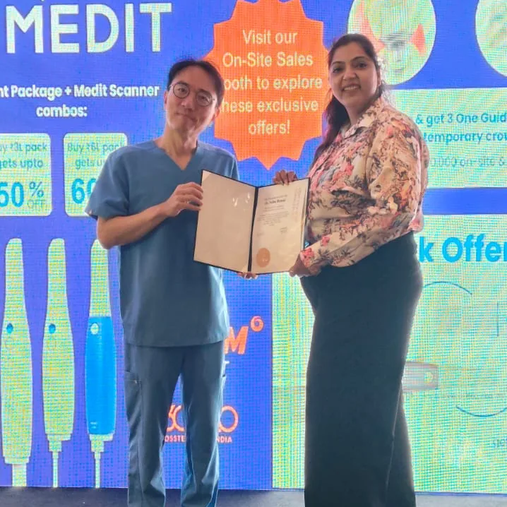 Dr. Neiha Bansal with a certificate at a Medit event