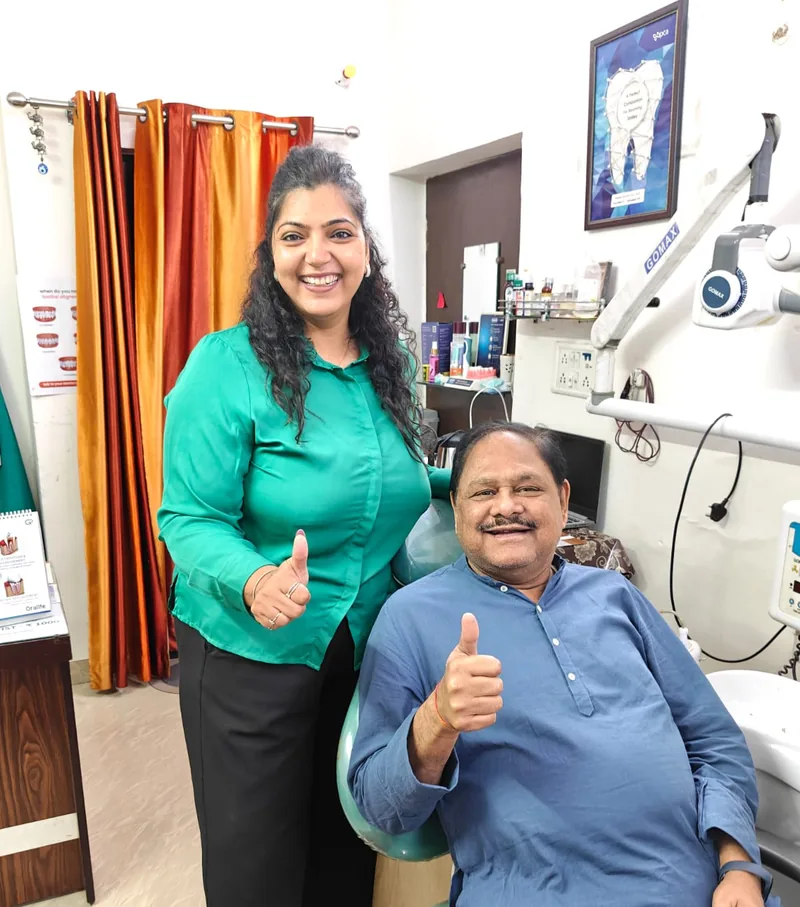 Dr. Neiha Bansal with a patient giving a thumbs-up at Dent-O-Care